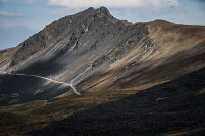 Scenic view of mountain road against sky