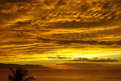 Scenic view of dramatic sky over sea during sunset