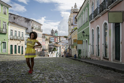 Full length rear view of woman walking on street