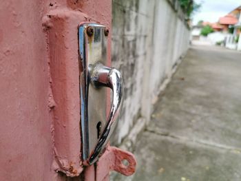 Close-up of old metal door on building