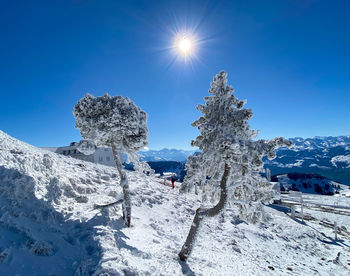 Scenic view of snowcapped mountains against clear blue sky