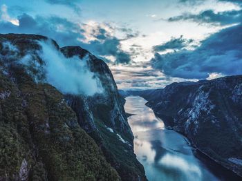 Scenic view of sea and mountains against sky