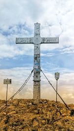 Low angle view of cross against sky