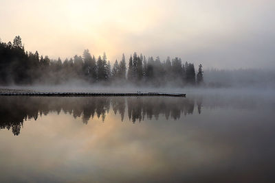 Scenic view of lake against sky at sunset