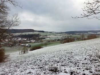 Scenic view of landscape against sky during winter