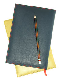 High angle view of pencil and book against white background
