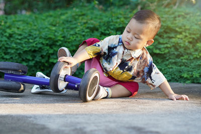 Cute boy playing toy outdoors