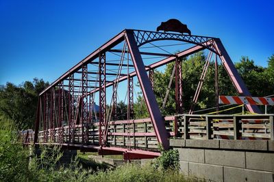 Abandoned bridge against blue sky