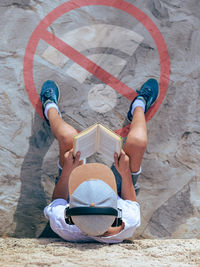 High angle view of boy playing with teddy bear
