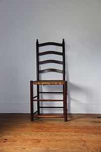 Close-up of chair on hardwood floor at home