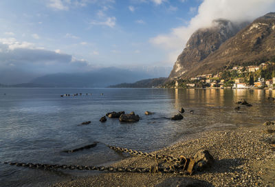 Scenic view of sea and mountains against sky
