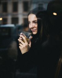 Portrait of a young woman drinking glass