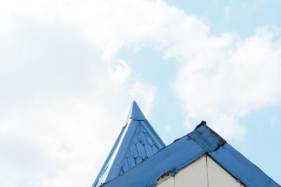 Low angle view of building against cloudy sky