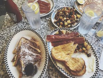 High angle view of breakfast in plates on table