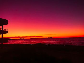 Scenic view of sea against romantic sky at sunset