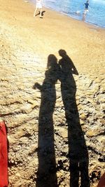 Shadow of people on beach