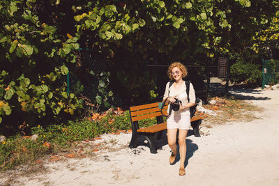 Side view of woman sitting on field