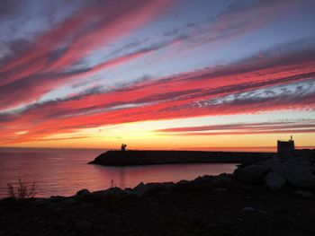 Scenic view of sea against romantic sky at sunset