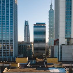 Modern buildings in city against clear sky