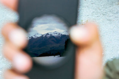 Close-up of human hand on mountain