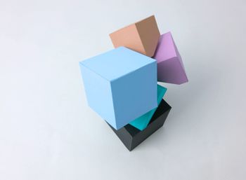 Close-up of colorful paper cubes on white background