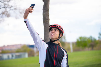 Male athlete taking selfie while standing park