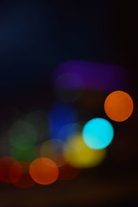 Close-up of illuminated lights against black background