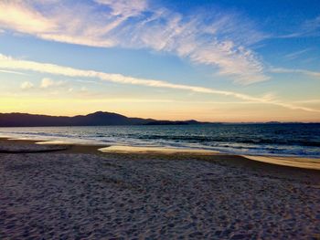 Scenic view of beach against sky during sunset