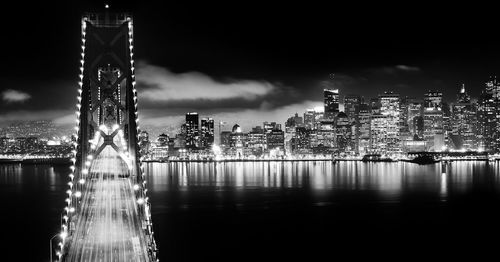 Illuminated cityscape against sky at night