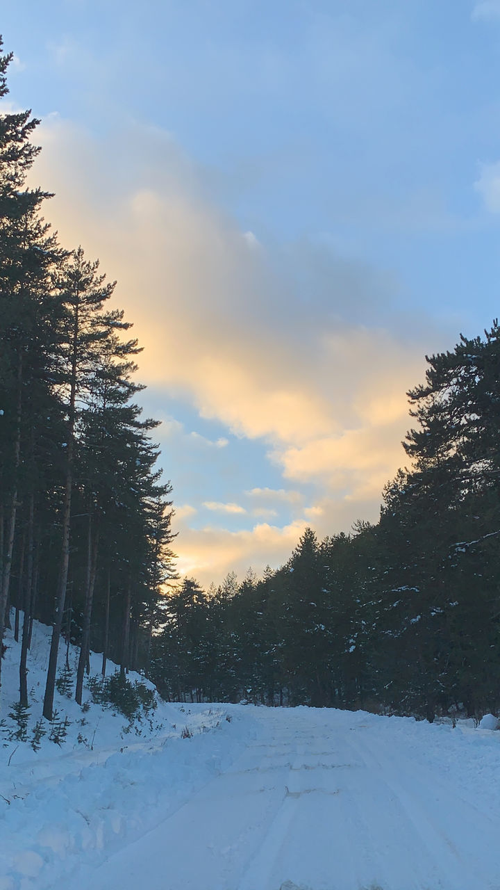 SNOW COVERED FIELD AGAINST SKY DURING SUNSET