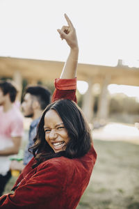 Portrait of smiling young woman standing outdoors