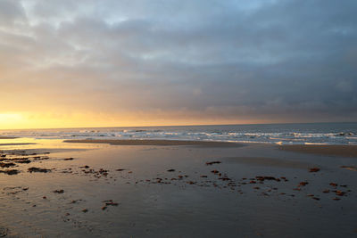 Scenic view of beach against sky during sunset