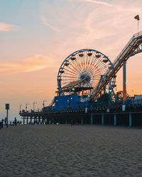Ferris wheel at beach during sunset