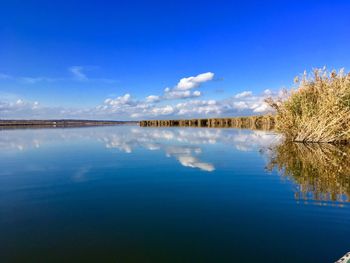 Scenic view of lake against blue sky