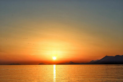 Scenic view of sea against orange sky