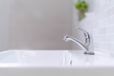 Close-up of faucet in bathroom