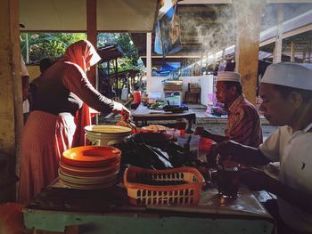 People working at market stall