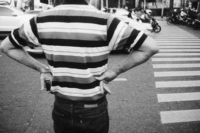 Midsection of man standing on road