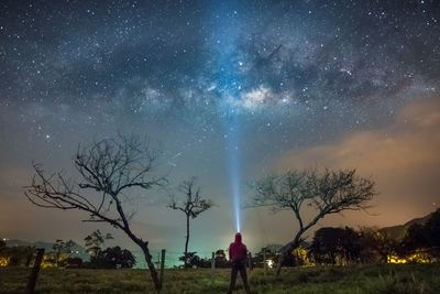 Scenic view of field against sky at night