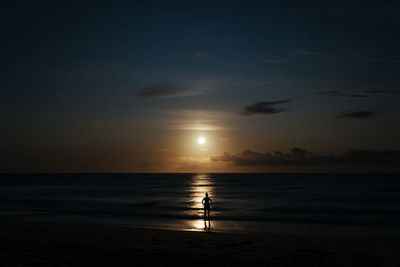 Scenic view of sea horizon against dark sky during moonrise of a full moon on a beach in bahia