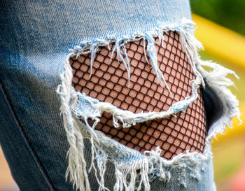 Close-up of person in torn jeans