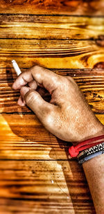 Close-up of man hand holding cigarette
