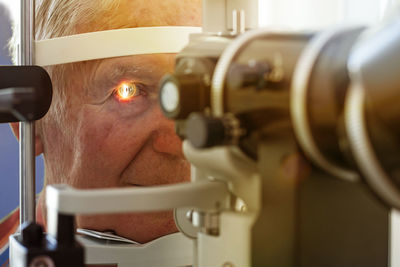 Close-up of man checking eyes