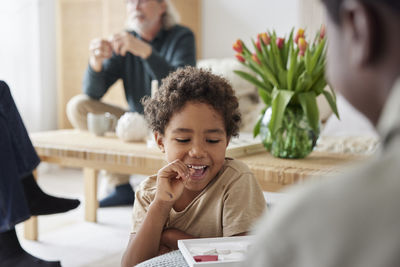 Family relaxing and playing games at home