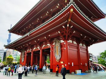 People at temple against clear sky