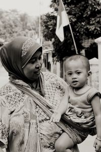 Portrait of mother and woman sitting outdoors