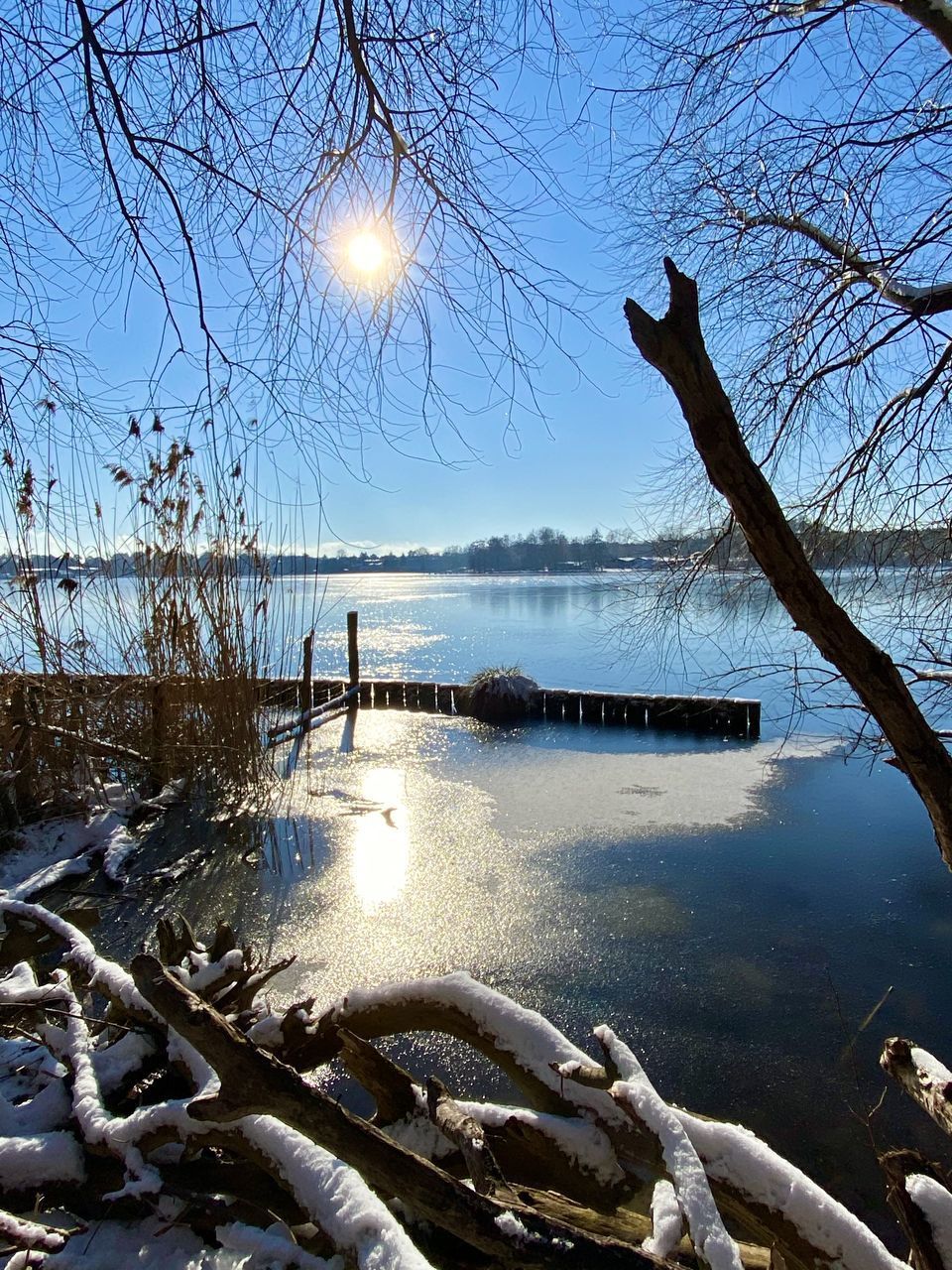 SCENIC VIEW OF LAKE AGAINST SNOW COVERED LANDSCAPE