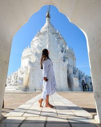 Full length of woman by historic building