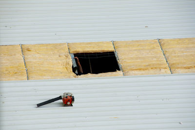 Man with umbrella on wall against building