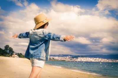 Rear view of person looking at sea against sky